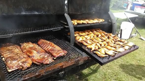 Ribs and chicken laid across the grates